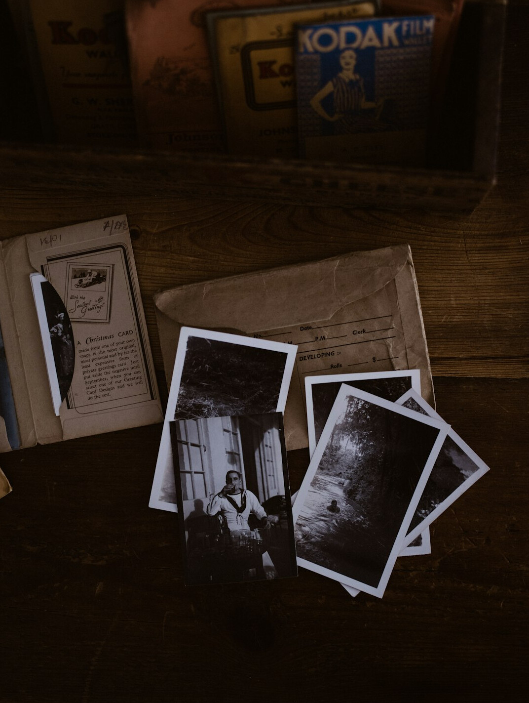 Aged archive documents and photographs spread on a table