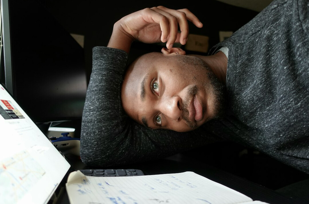 person thinking with notebook
